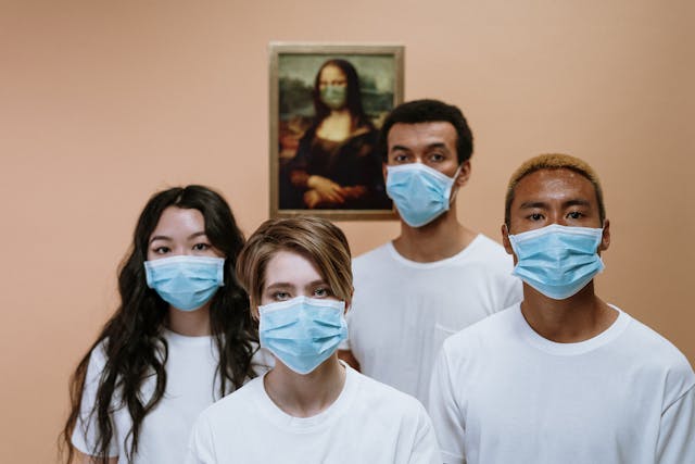four people wearing medical masks