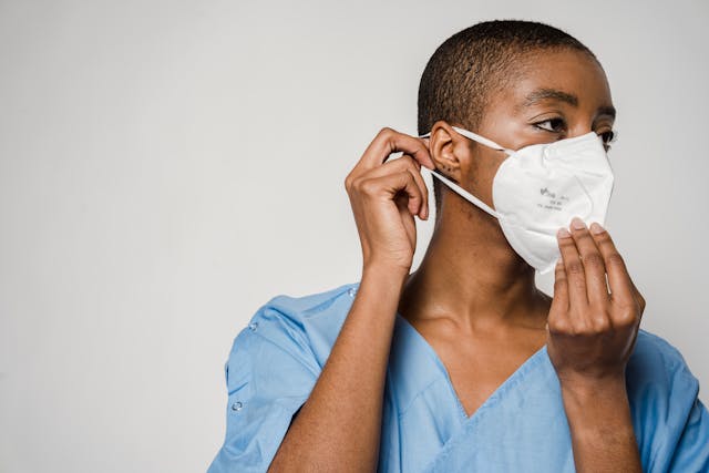 healthcare provider putting on a mask